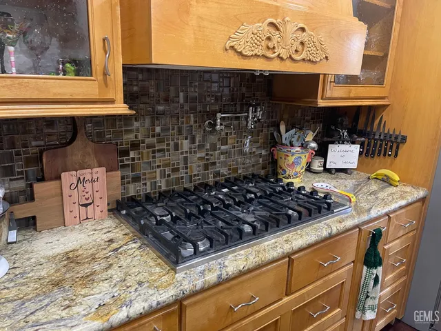 a kitchen with an oven a stove and a wooden cabinets