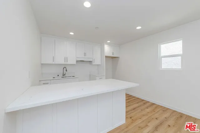 a kitchen with sink and cabinets