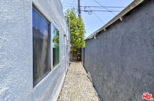 a bedroom with a large bed and a potted plant