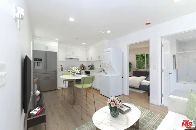 a kitchen with granite countertop white cabinets and white appliances