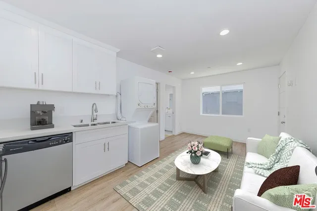 a view of a room with wooden floor and white walls