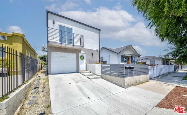 a front view of a house with yard and hallway