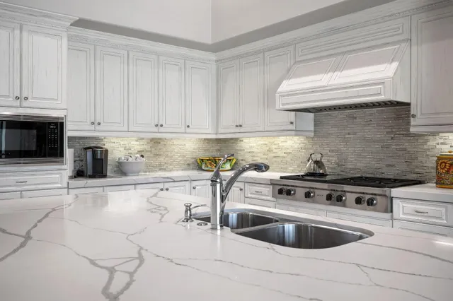 a bathroom with a granite countertop sink a toilet and a shower