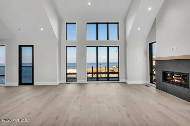 a view of an empty room with a fireplace and a window