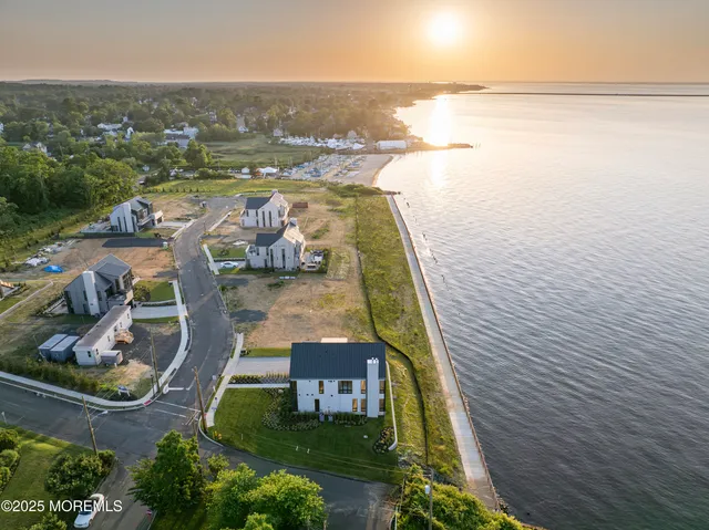 an aerial view of a house with outdoor space swimming pool and ocean view