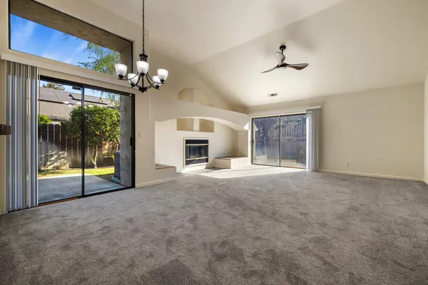 a view of a livingroom with a ceiling fan and window