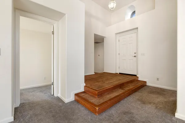 a view of empty room with fireplace and windows