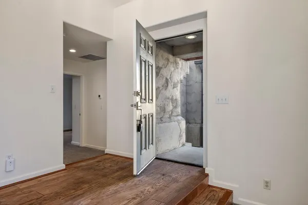 a view of a bathroom with a glass door and a window
