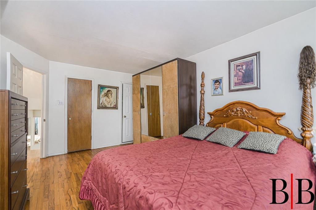 2042 Ralph Avenue Brooklyn, NY 11234 - Photo 12 of 24 a bedroom with a bed and a painting on the wall