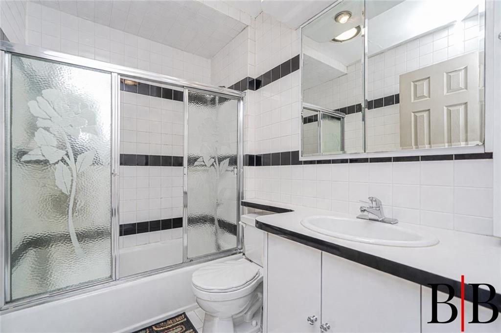 2042 Ralph Avenue Brooklyn, NY 11234 - Photo 15 of 24 a bathroom with a sink toilet and shower