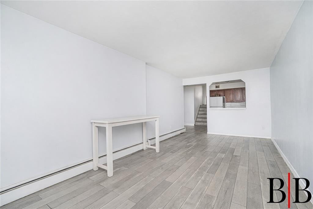 2042 Ralph Avenue Brooklyn, NY 11234 - Photo 19 of 24 an empty room with wooden floor and windows