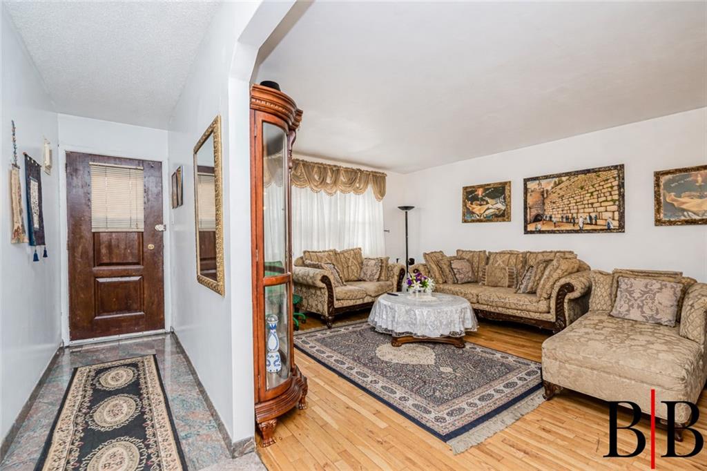 2042 Ralph Avenue Brooklyn, NY 11234 - Photo 4 of 24 a living room with furniture and a rug