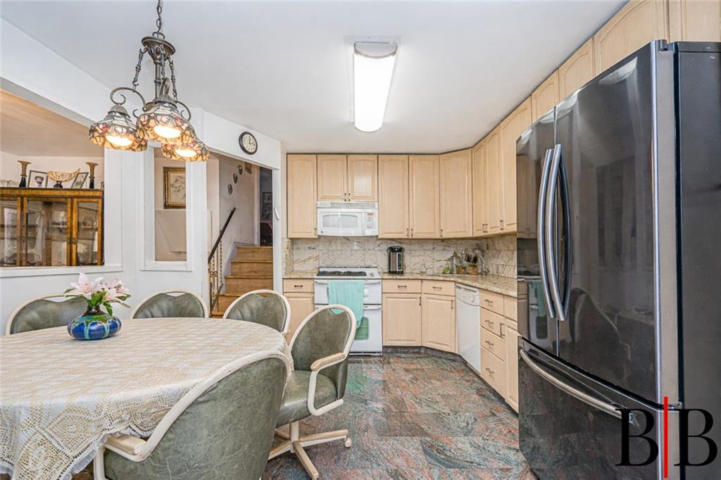2042 Ralph Avenue Brooklyn, NY 11234 - Photo 5 of 24 a kitchen with refrigerator cabinets and large windows