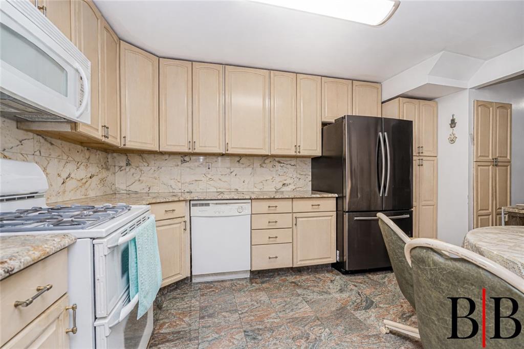 2042 Ralph Avenue Brooklyn, NY 11234 - Photo 6 of 24 a kitchen with stainless steel appliances granite countertop a refrigerator sink and cabinets