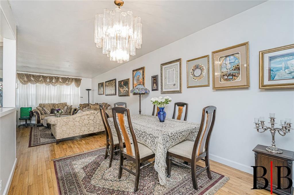 2042 Ralph Avenue Brooklyn, NY 11234 - Photo 9 of 24 a view of a dining room with furniture a chandelier and wooden floor