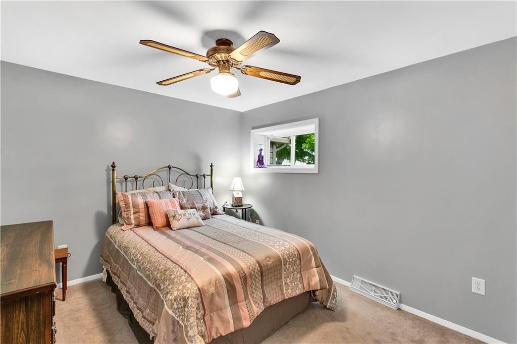 149 Fredericktown Road Midland, PA 15059 - Photo 13 of 50 a bedroom with a bed and a chandelier