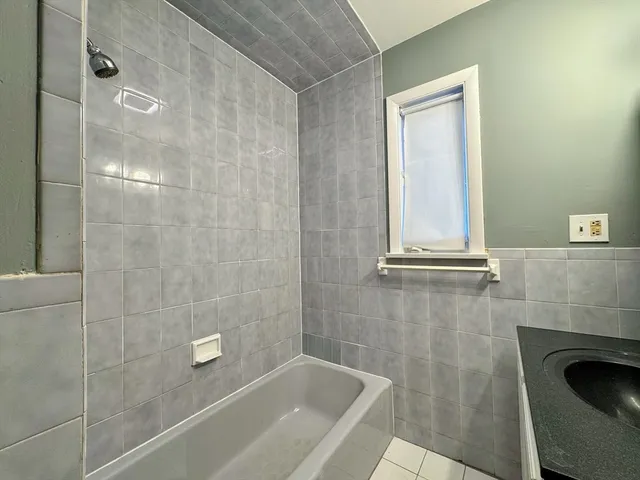a bathroom with a tub and a shower