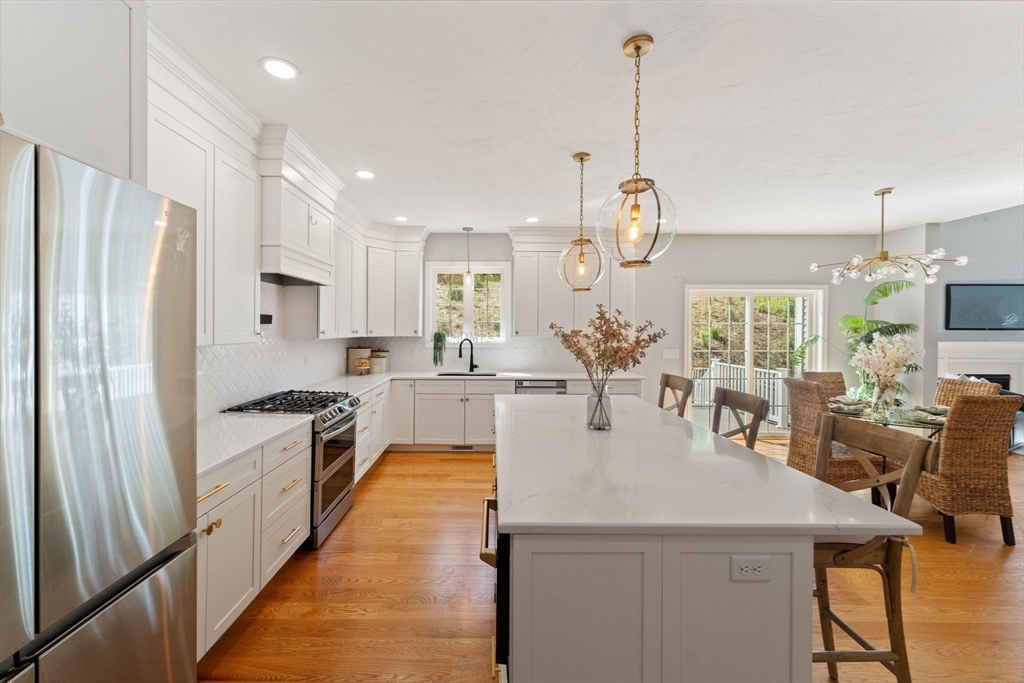 11 Chadwick Road Hudson, MA 01749 - Photo 15 of 39 a large kitchen with kitchen island a stove a sink a center island and furniture