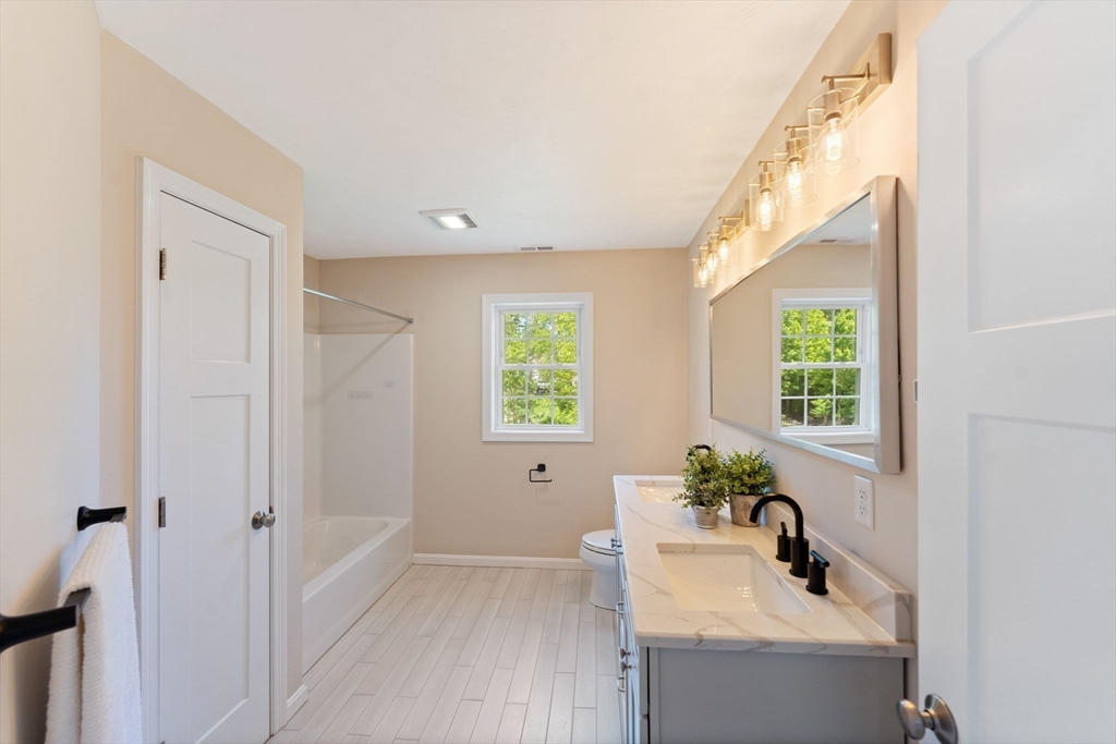 11 Chadwick Road Hudson, MA 01749 - Photo 33 of 39 a bathroom with a sink a window and a mirror