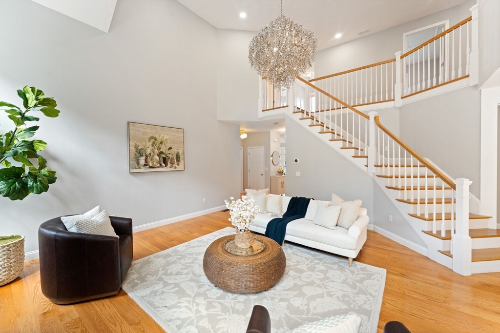 11 Chadwick Road Hudson, MA 01749 - Photo 8 of 39 a living room with furniture and a chandelier