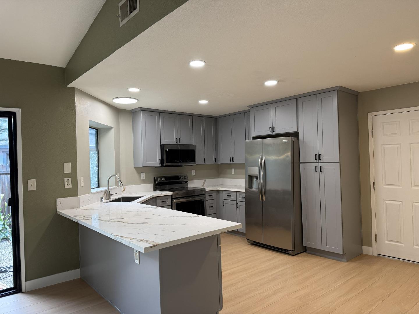 1870 Azurite Way Sacramento, CA 95833 - Photo 13 of 38 a kitchen with refrigerator cabinets and wooden floor