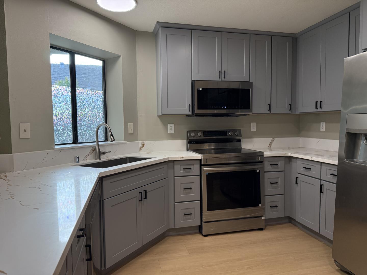1870 Azurite Way Sacramento, CA 95833 - Photo 15 of 38 a kitchen with stainless steel appliances granite countertop a sink and a stove