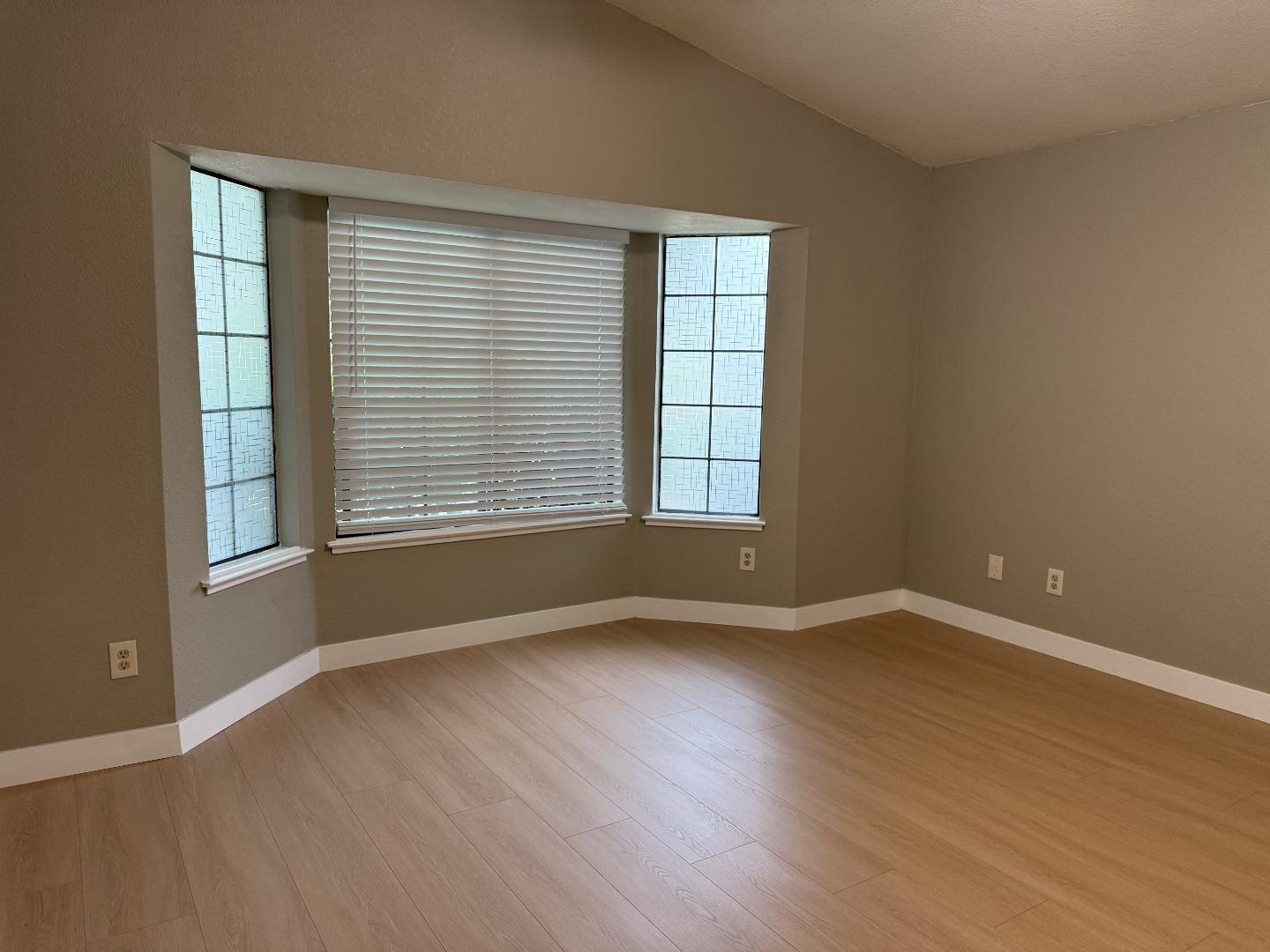 1870 Azurite Way Sacramento, CA 95833 - Photo 18 of 38 an empty room with wooden floor and windows