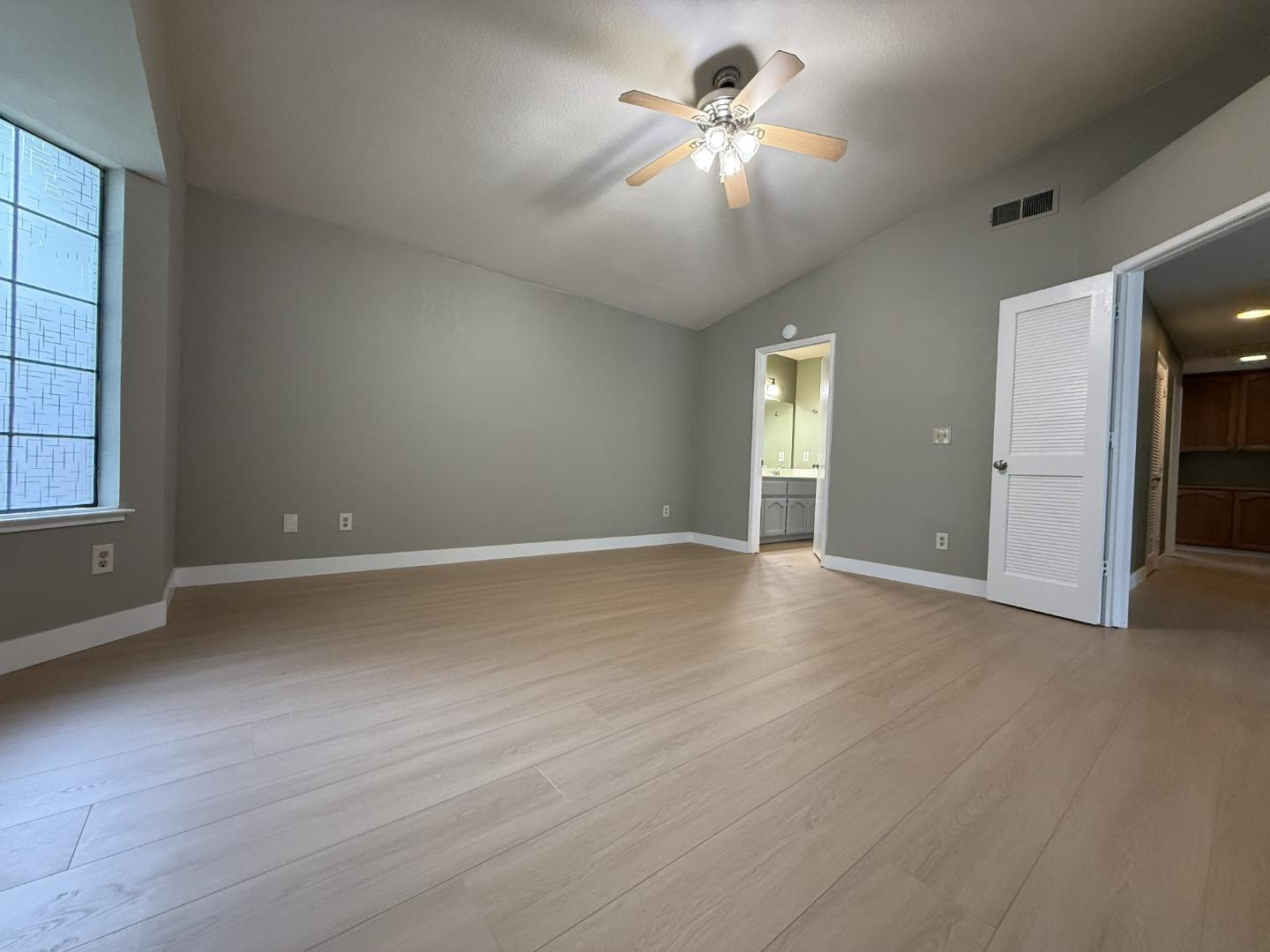 1870 Azurite Way Sacramento, CA 95833 - Photo 20 of 38 an empty room with chandelier fan and windows