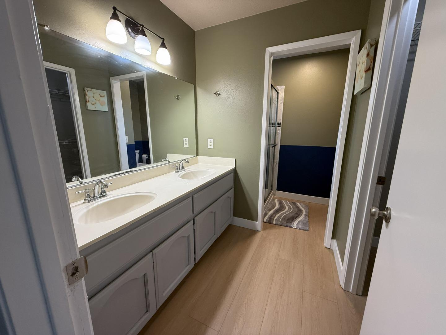 1870 Azurite Way Sacramento, CA 95833 - Photo 23 of 38 a en suite bathroom with a double vanity sink and a mirror