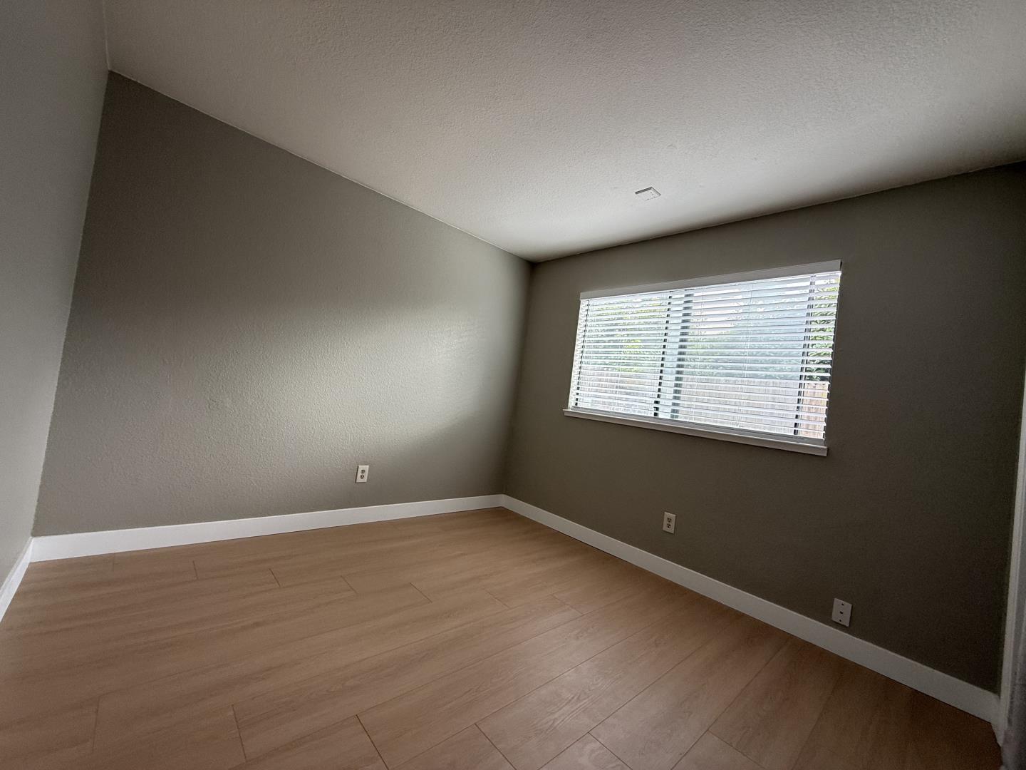 1870 Azurite Way Sacramento, CA 95833 - Photo 31 of 38 an empty room with wooden floor and windows