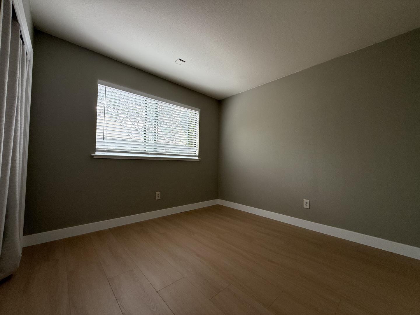1870 Azurite Way Sacramento, CA 95833 - Photo 33 of 38 an empty room with wooden floor and windows