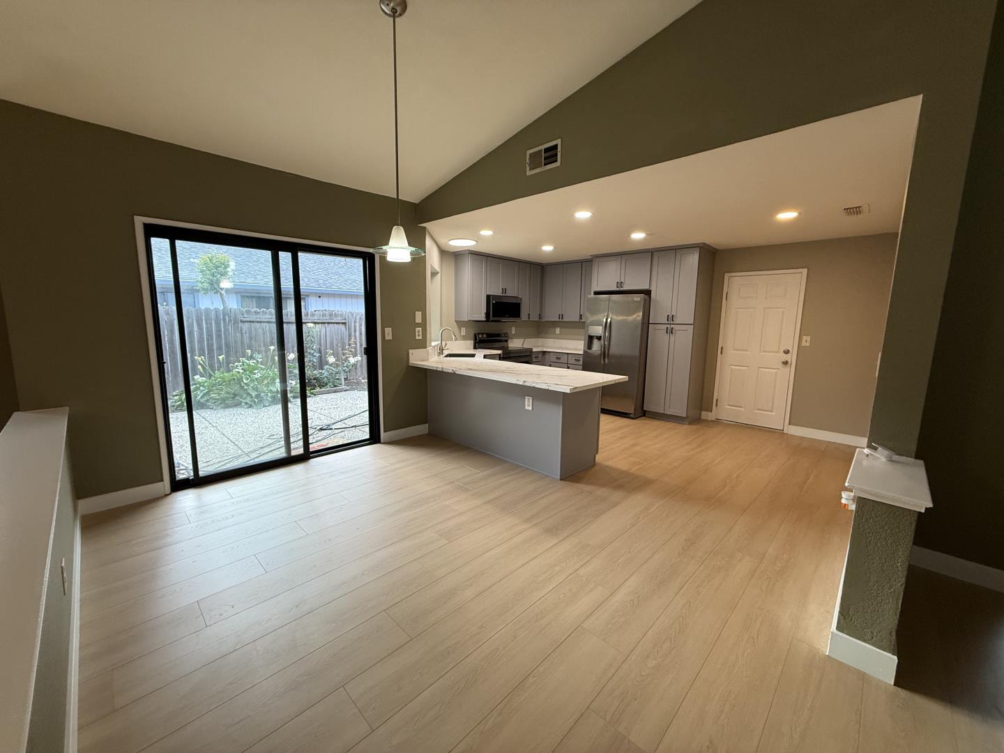 1870 Azurite Way Sacramento, CA 95833 - Photo 10 of 38 a open kitchen with stainless steel appliances granite countertop a refrigerator a sink a stove and a wooden floors