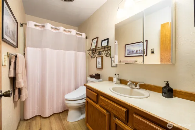 a bathroom with a sink toilet and shower