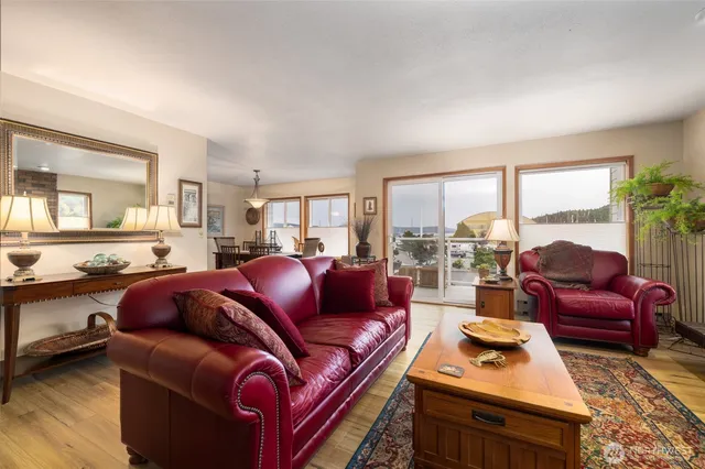 a living room with furniture a large window and a table