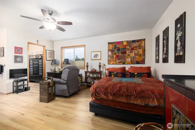a bedroom with furniture and wooden floor