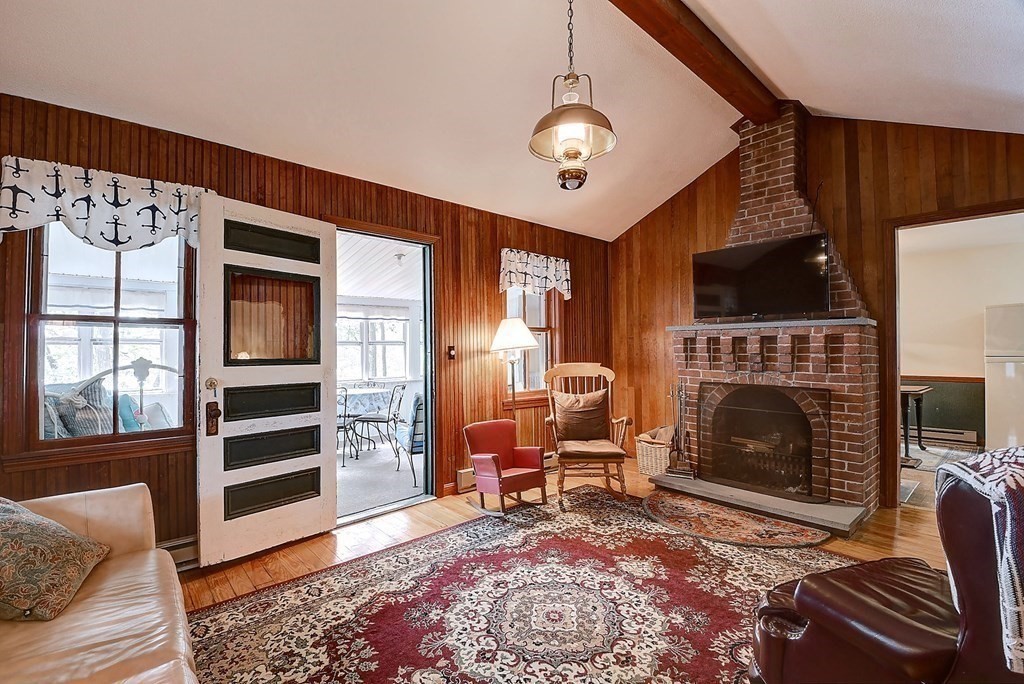 20 Old Acres Road Holland, MA 01521 - Photo 11 of 36 a living room with furniture a flat screen tv and a fireplace