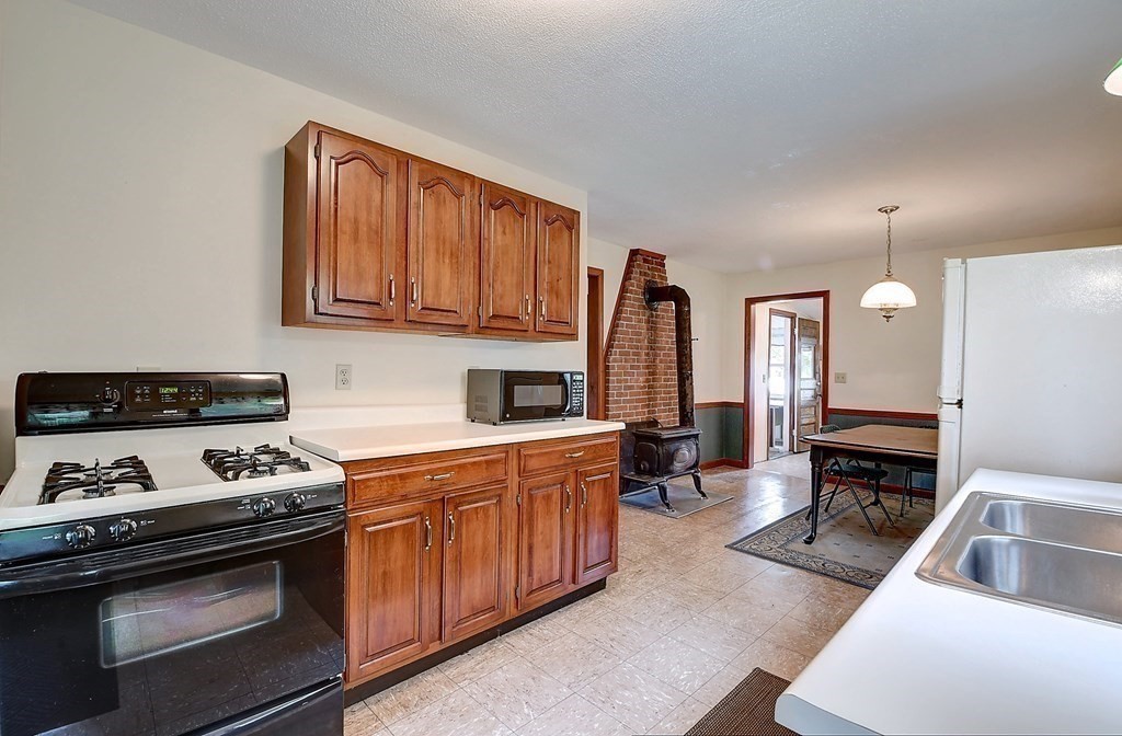 20 Old Acres Road Holland, MA 01521 - Photo 4 of 36 a kitchen with stainless steel appliances granite countertop a stove a sink and a microwave