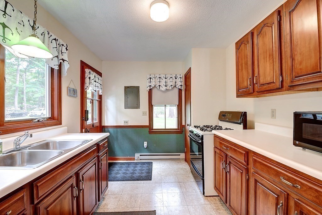 20 Old Acres Road Holland, MA 01521 - Photo 6 of 36 a kitchen with a sink stove and cabinets
