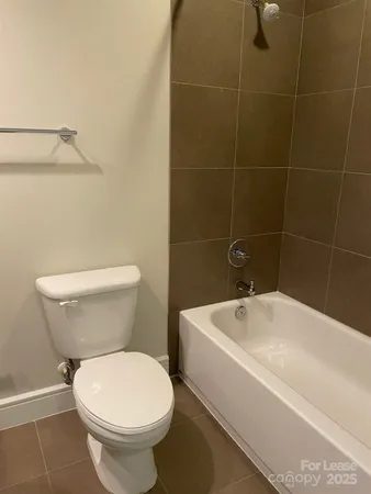 a white toilet sitting next to a bathroom sink