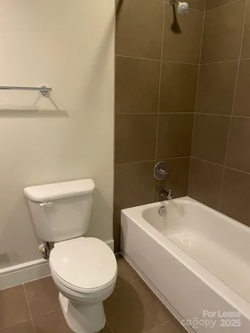 a white toilet sitting next to a bathroom sink