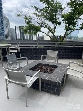 a roof deck with table and chairs