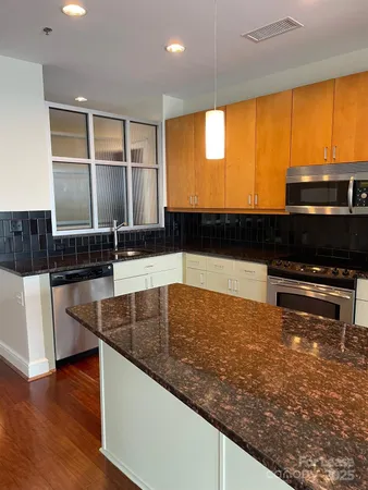a kitchen with stainless steel appliances a sink and a microwave