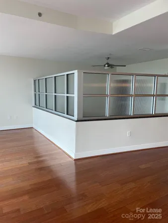 a view of an empty room with wooden floor