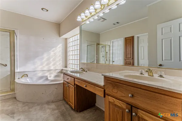 a bathroom with a granite countertop sink and a bathtub