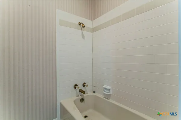 a bathroom with a sink a toilet and a window