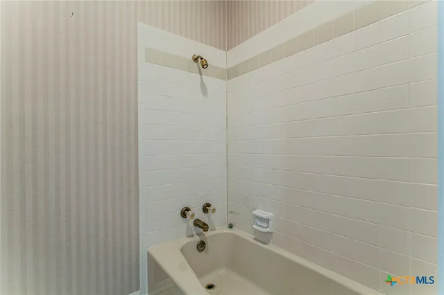 a bathroom with a sink a toilet and a window