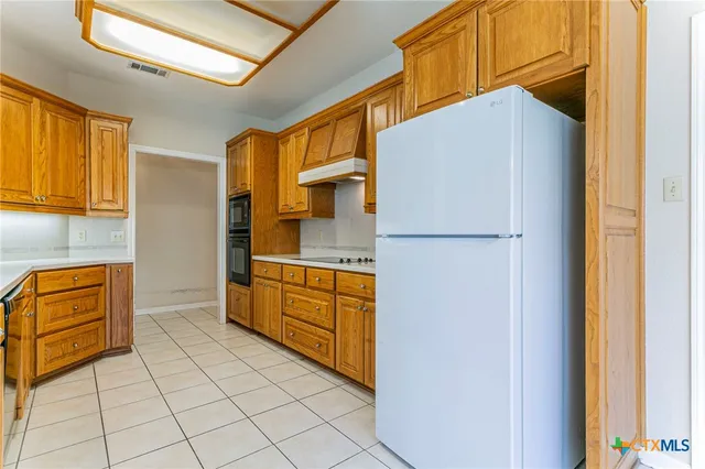 a kitchen with stainless steel appliances granite countertop a stove and a sink