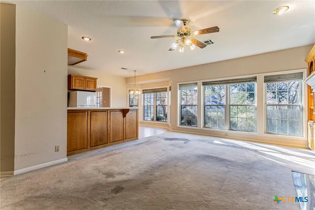 a kitchen with a cabinets counter top space appliances and a window