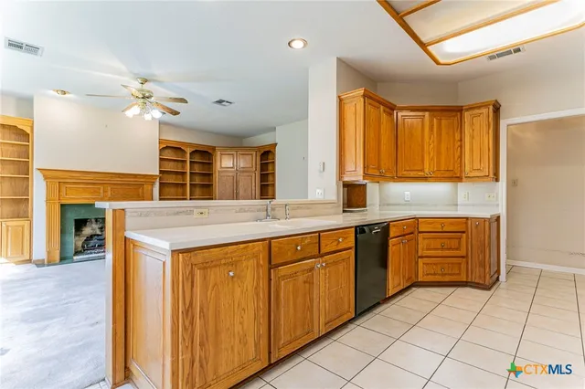 a view of a kitchen with a sink and a refrigerator