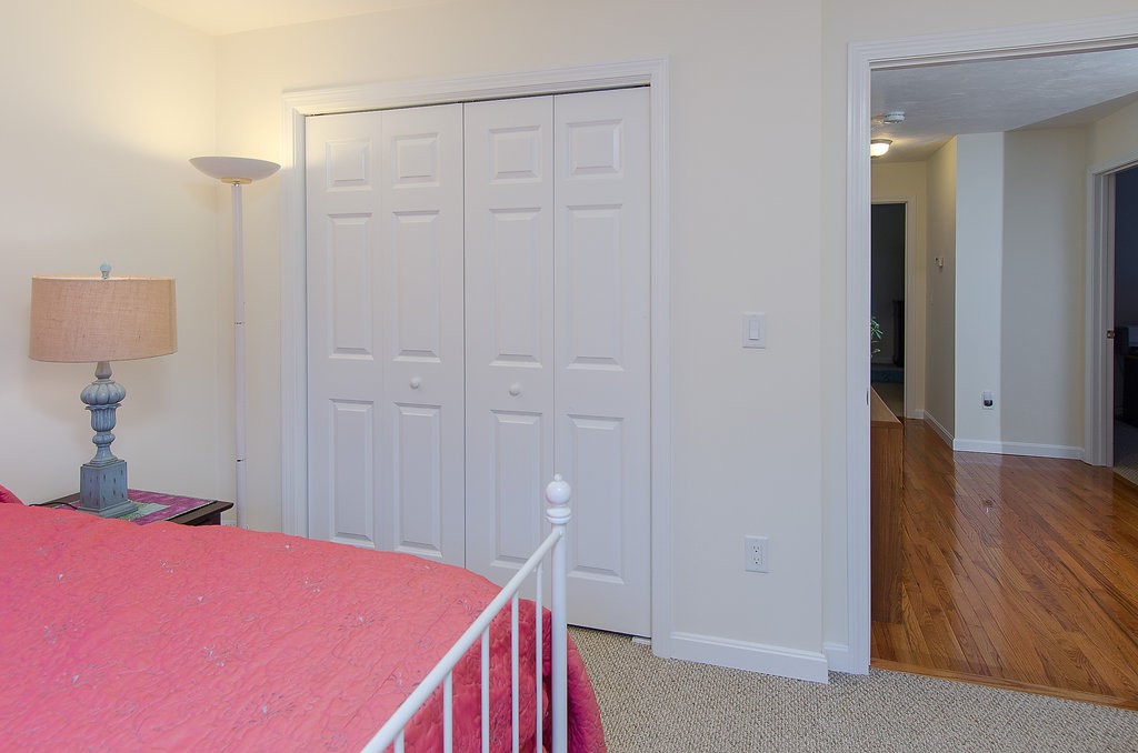 2 Sterling Lane, Unit 2 Walpole, MA 02081 - Photo 13 of 27 a bedroom with a bed and a dresser